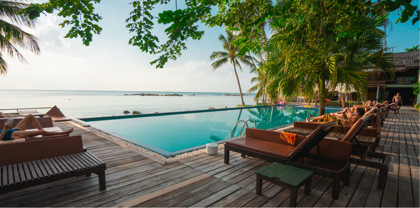 Loungers beside a pool overlooking the sea